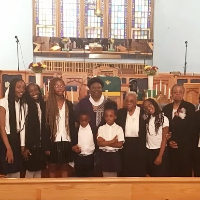 Pastor Bell with children and youth members at Zion AME Church